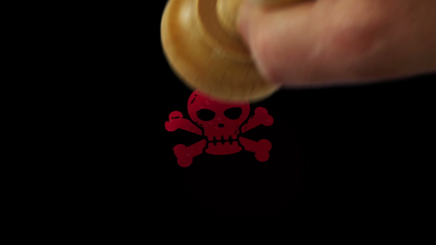 Skull stamp and hand stamping impact isolated animation. Danger, warning, piracy and toxic symbol 3D rendered concept. Alpha matte channel.