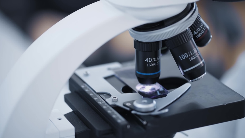 scientist or researcher examines samples of a modern electron diode microscope close-up in a modern biochemical laboratory. Royalty-Free Stock Footage #1089893597