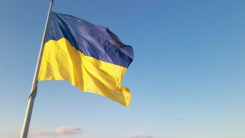Highly detailed fabric texture flag of Ukraine. Slow motion of Ukraine flag waving background sky blue and yellow national color Ukrainian yellow-blue. Ukraine flag wind waving national symbol country