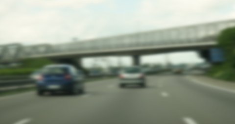 Handheld 4K DCI footage of cars driving on French highway defocused blur footage