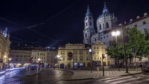 Night panoramic view of the illuminated malostranske namesti square timelapse hyperlapse in prague which lies just under the prague castle and which is famous for church of saint nicolas. PRAGUE
