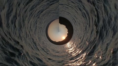 360 degrees of Equirectangular to Stereographic Panorama.
Ocean water fast moving. Beautiful view of sunset in rocky hills on the sea. Spherical projection. Loop rotate.