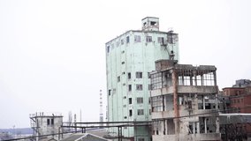 An old, abandoned, commercial building with industrial chimneys in the background. - Powered by Shutterstock - Get 15% off with code: PIKWIZARD15