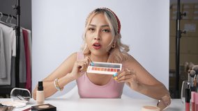 Young beautiful Asian woman and professional beauty make up artist vlogger or blogger recording makeup tutorial to share on website or social media. Business online influencer on social media concept. - Powered by Shutterstock - Get 15% off with code: PIKWIZARD15