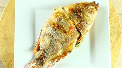 Close up grilled tilapia fish , Thai famous street food.