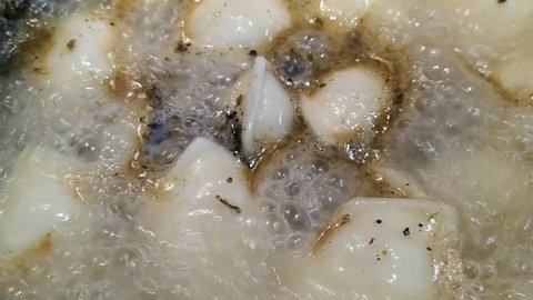 cooking dumplings in a saucepan closeup video
