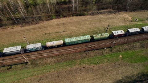 Freight Cars Deliver bulk Materials and gravel. Open Hoppers on railroad. Freight train with petroleum tank cars. Rail cars carry oil, crude and gas, ethanol. Railway logistics explosive cargo. 
