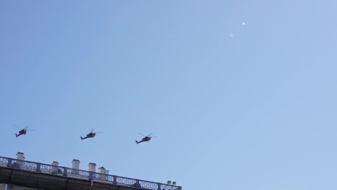 May 9, 2021 St.Petersburg Russia four military helicopters in the sky in a row flying in the clear blue sky