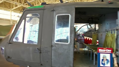 Honolulu, Hawaii, United States - August 2016: helicopter Bell UH-1 Iroquois Utility of 1960s in Hangar 79 of the Pearl Harbor Aviation Museum of Hawaii. American helicopter served in Vietnam War