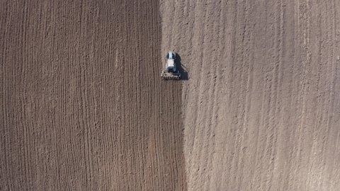 aerial view of a tractor that plows the land for sowing. Spring plow.