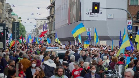 Ukrainian women and men protest against the war and Russian leader Putin. death and war in Ukraine. people with placards, flags of ukraine, italy, america. Europe, Italy Milan, April 25, 2022