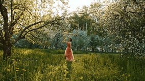 A woman in a luxurious evening dress of turquoise color walks in the garden among blooming roses. Princess with stylish styling on her loose hair. Fashionable image of a graduate girl at a prom party - Powered by Shutterstock - Get 15% off with code: PIKWIZARD15