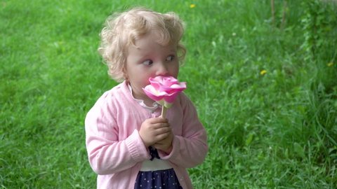 little girl with candy,big lollipop flower girl eating