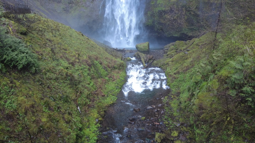 Multnomah Falls plunges over 500 feet from a cliff into the scenic Columbia River Gorge, Oregon. This narrow canyon, with the Columbia River flowing through it, separates Oregon and Washington.