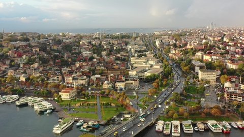 Wide aerial view of a colorful and vibrant morning sunrise in Istanbul Turkey after an early rain shower as cars and busses cross Ataturk Bridge
