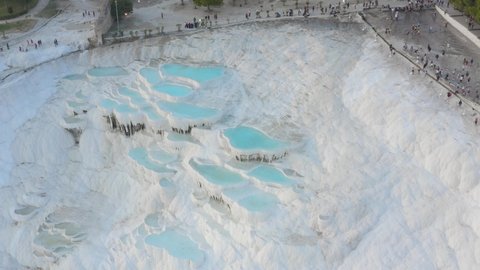 Dramatic aerial view of Travertines with turquoise water in Pamukkale, Turkey. Pamukkale (Cotton Castle) or ancient Hierapolis (Holy City), which was declared the world heritage.