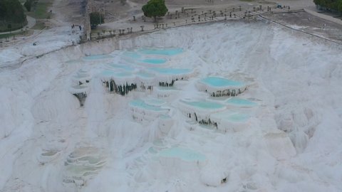 Pamukkale (Cotton Castle) or ancient Hierapolis (Holy City), which was declared the world heritage site by UNESCO. Aerial view of Travertines with turquoise water in Pamukkale, Turkey