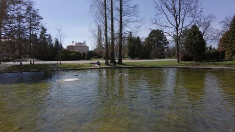 First Person View Of Scenic Lake With Water Fountain On Sunny Day In Olomouc City, Smetanovy Sady Gardens Park In Czechia