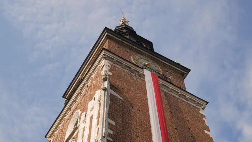 Town Hall Tower (Wieża Ratuszowa Kraków) on Main Market Square in the Old Town district of Krakow, Poland. Decorated with the Polish flag for celebration of 3 May Constitution Day.