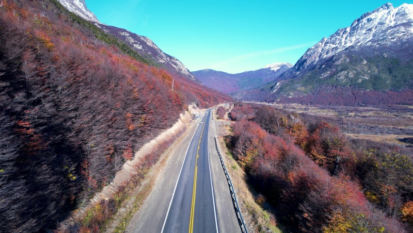 Patagonia road at Ushuaia Argentina province of Tierra del Fuego. Stunning road between nevada mountains and colorful forest trees. Ushuaia Argentina. Patagonia Argentina at Ushuaia Argentina. Royalty-Free Stock Footage #1089921157