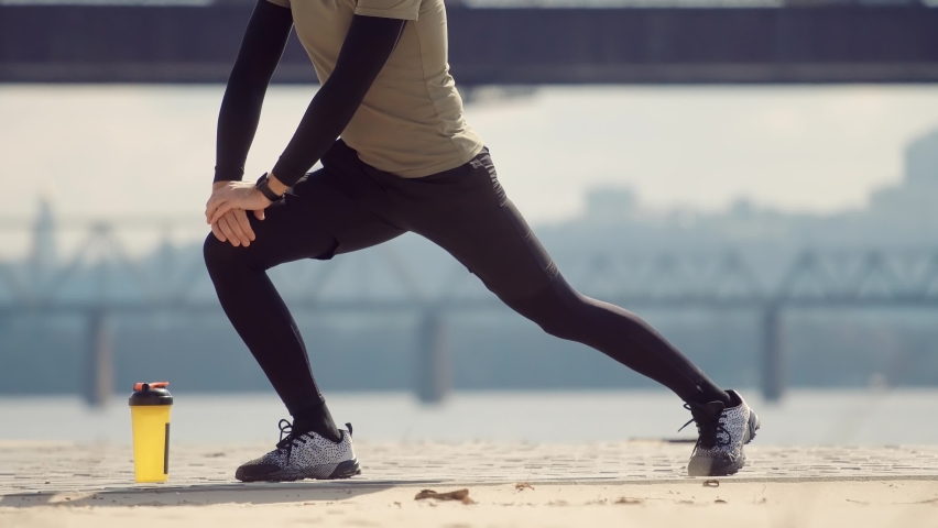 Man Limbering-Up And Stretching Legs After Running Jog Workout. Runner Stretching And Warming-Up Before Running. Athlete Training Exercising In Sportswear Warm-Up.Fitness Runner Cardio Workout Outdoor Royalty-Free Stock Footage #1089921769