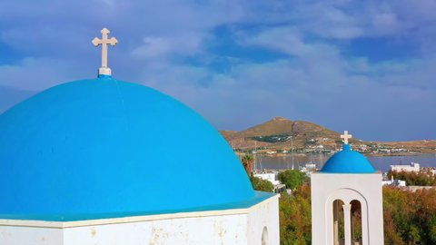 Holy cross on white and blue greek church and panorama of Paros island, Greece