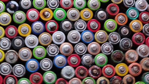 Close-up of used oxidized AA batteries. Finger batteries rotate in a circle. 