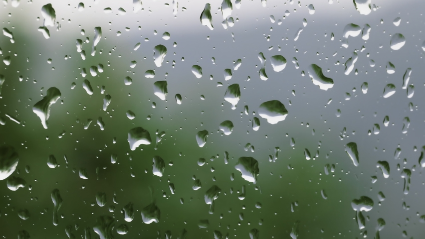 macro drops of water.Drops of water on glass. Large raindrops hit a window pane during a summer storm. macro drops of water.texture water.slider shot