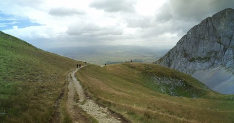 Ultra-wide view on the footpath on Savin Kuk mountain top on a cloudy, windy day in Durmitor National Park, Montenegro. 4K DCI