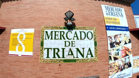 Sevilla, Spain, September 12, 2021: The entrance to the Mercado de Triana, an indoor market in the Triana district area of the Andalusian city of Seville. Tiled decoration with the name of the market.