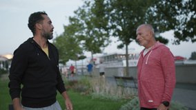Happy senior man with his mature son exercising together in park. - Powered by Shutterstock - Get 15% off with code: PIKWIZARD15