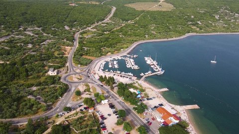 Aerial drone footage of the medieval Krk old and and marina in Krk island in the Adriatic sea in Croatia at sunset