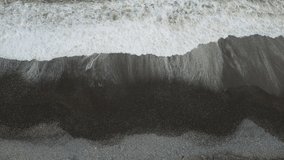 Drone video of waves on a rocky beach. Shot consists of flying towards the right at a very slow speed.