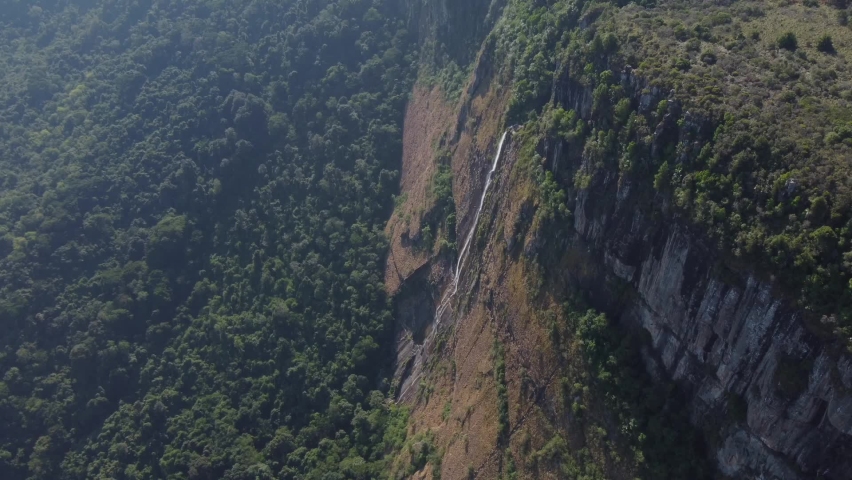 Drone shot of Mutarazi Falls in Zimbabwe - drone is descending, flying towards one of the waterfalls. Snippet could ideally be used for travel related videos or Zimbabwe or Africaies.