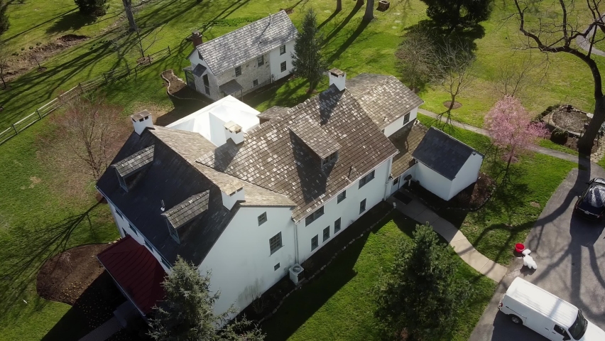 Drone flying over Duportail house Chesterbrook in Pennsylvania on a clear sunny day.