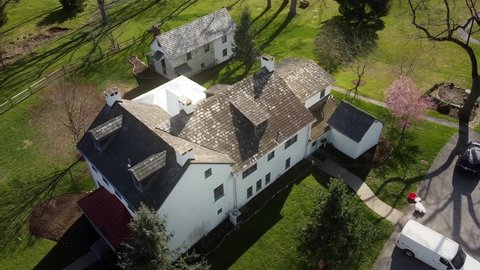 Drone flying over Duportail house Chesterbrook in Pennsylvania on a clear sunny day.
