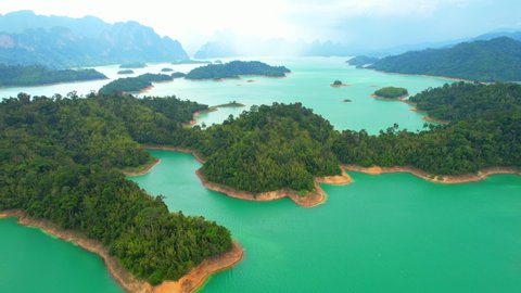 A drone flying over a dam in a beautiful tropical forest. top view. Ratchaprapha dam, Surat Thani Province, Thailand. Aerial view 4K. cinematic drone shots
