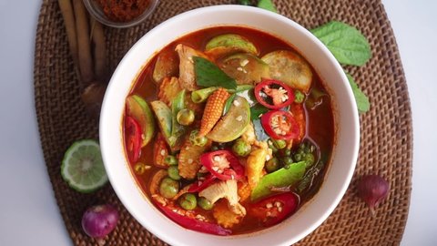 Thai Wild Curry in White Bowl and Ingredients on Set,The Thai Traditional Menu,It's Spicy and Hot From Variety of Herbs
