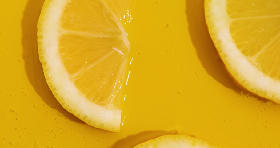 Top view rotation of fresh slice of lemons juice and gel serum, organic cosmetics, vitamin C, fresh citrus fruits, Lemon extract Royalty-Free Stock Footage #1089941121