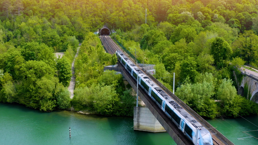 Tunnel entrance of high speed train track - aerial view, drone footage.  train at rural scene in summer. The train rides through rural countryside in sunrise. train rides along the beautiful summer.  | Shutterstock HD Video #1089942411