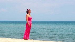 Beautiful young woman is doing exercises yoga on the seashore, Yoga - sun salutation , Video clip