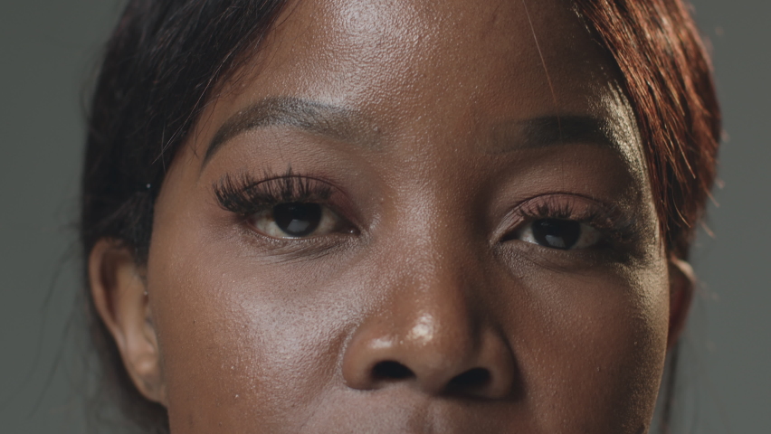 Closeup brown eyes with long lashes of pensive black female. African american woman blinking looking at camera. ProRes Royalty-Free Stock Footage #1089945689