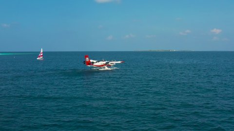 Maldives: 20 January 2022 . Seaplane or hydroplane is taking off or landing on a water. Maldivian Airlines arrives, hydroplan of TMA company
