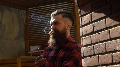 Bearded man, barber with razor. Mens hair styling and hair cutting in a barber shop.
