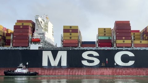 Oakland, CA - May 5, 2022: 4K HD video of cargo ship MSC BEATRICE entering the Port of Oakland. Mediterranean Shipping Company is the worlds 2nd largest shipping line. 6x normal speed