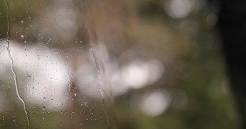 Drops sliding on window glass. Rain drops on glass