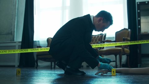 Detective Collecting Evidence in a Crime Scene. Forensic Specialists Making Expertise at Home of a Dead Person. Homicide Investigation by Police Officer.