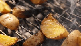 Potato cooking on grill. Vegetarian barbecue 4k video. Summer food