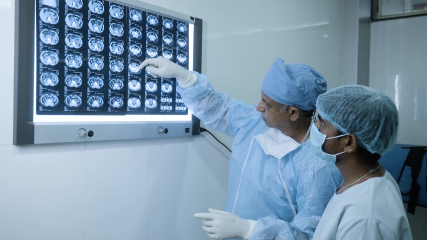 doctors in opereation gown analysing x report before performing surgery at hopsital - conept of medical expertise, examining and medicare Royalty-Free Stock Footage #1089956133
