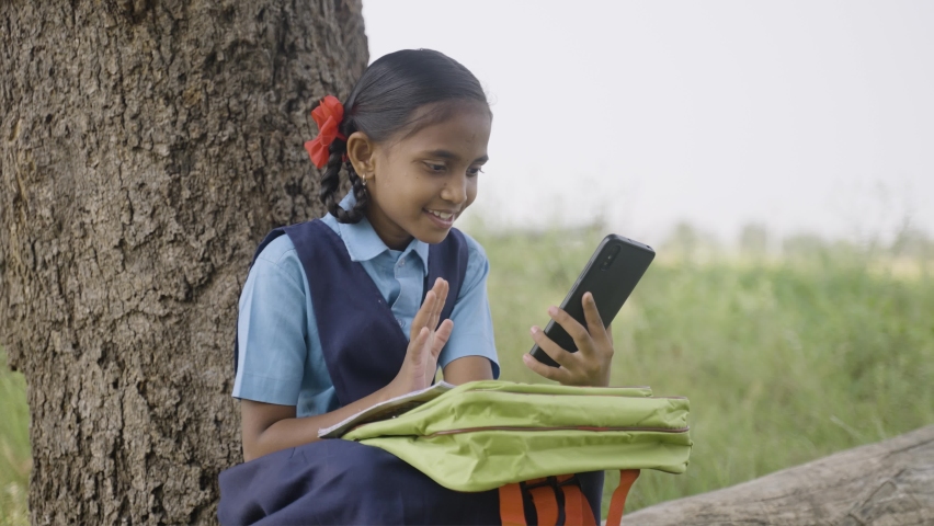 Village listening online class from mobile phone near agriculture farm land by taking notes - concept of education, technology, distance learning | Shutterstock HD Video #1089956137